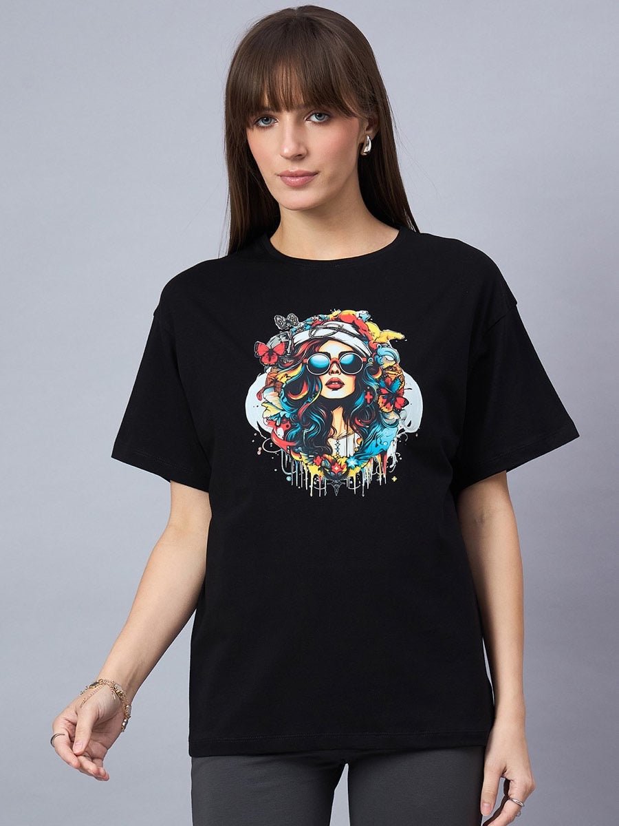 Woman wearing a 98degreenorth Black Typography Printed Cotton T-shirt with an oversized fit and drop shoulders.