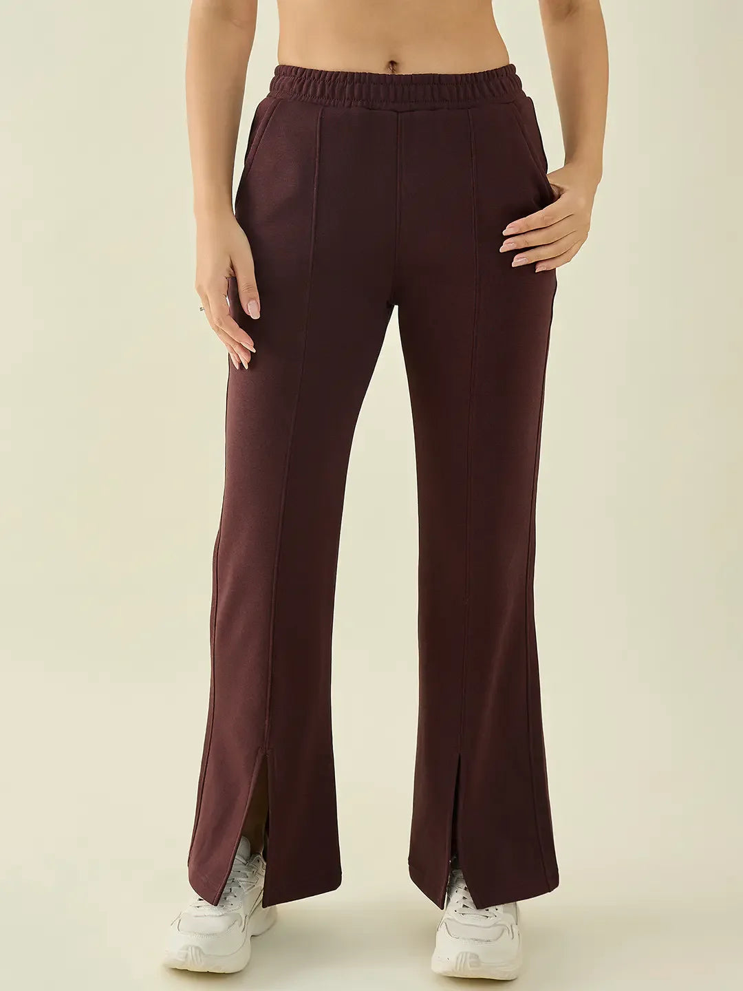 A woman wears 98degreenorth Dark Wine Fleece Flared Sweatpants—bootcut, warm winter pants—perfect for casual wear in India.