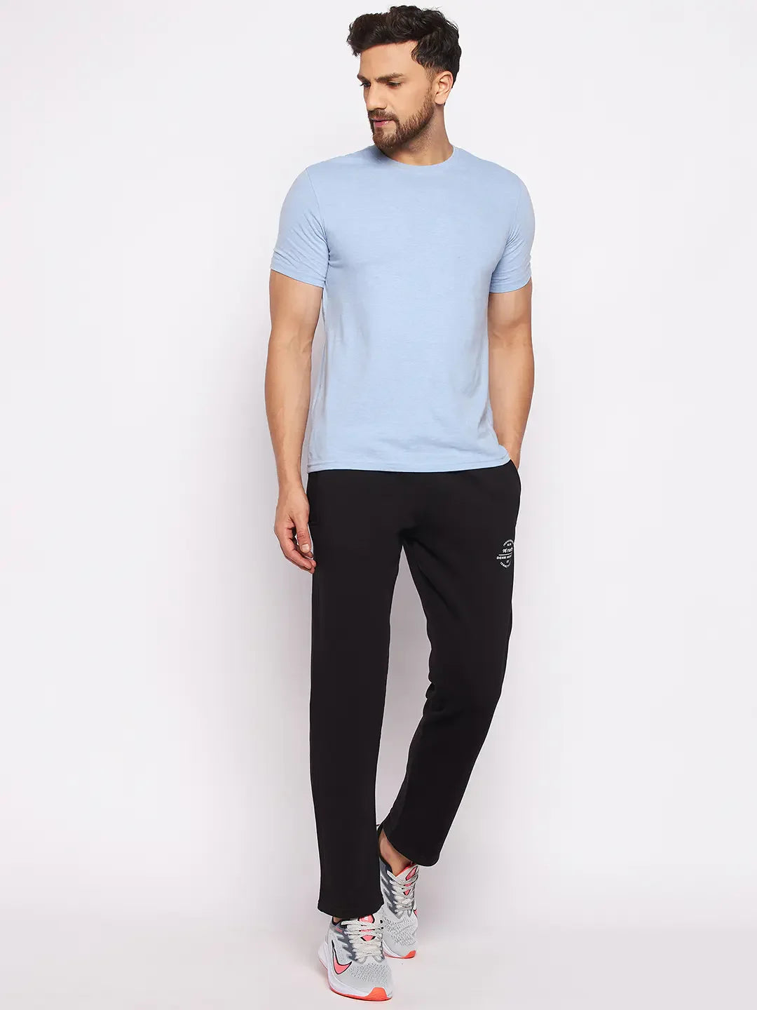 Man wearing 98degreenorth Men’s Black Fleece Trackpants, warm winter joggers, against a plain white background.
