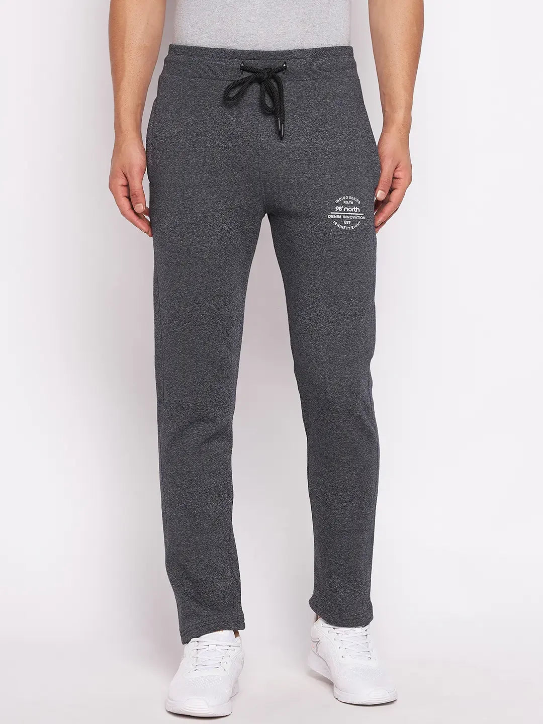 Man in 98degreenorth Men’s Black Jaspe Fleece Trackpants, stretchable winter lounge pants, against plain background.