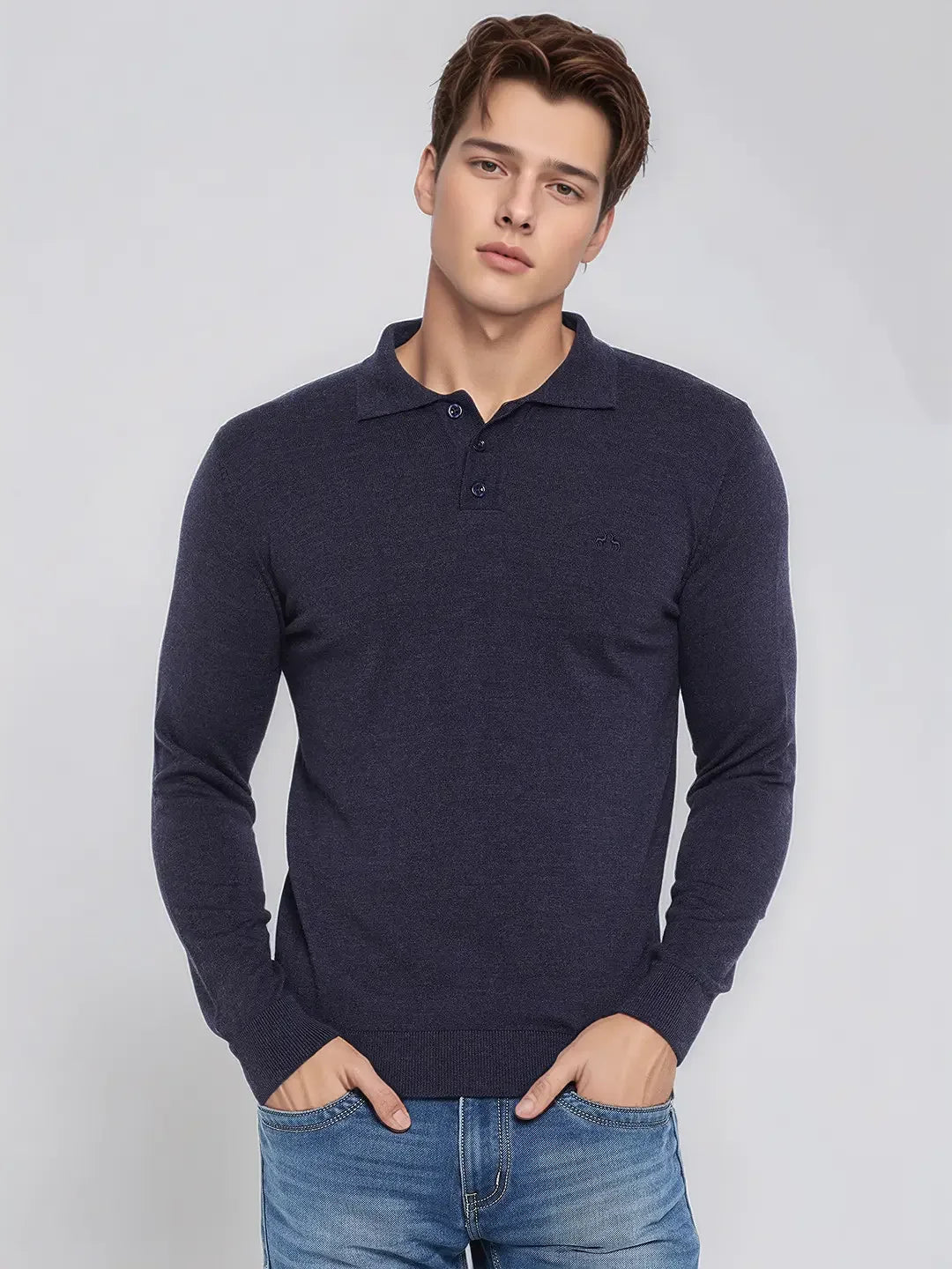 A man wears the 98degreenorth Men’s Dark Denim Merino Wool Polo Neck Sweater, a smart casual handcrafted pullover.