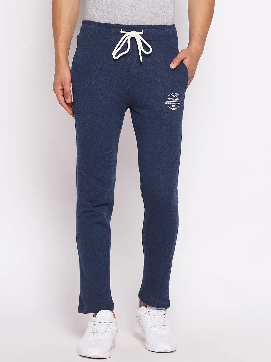 Man wearing 98degreenorth Men’s Denim Fleece Trackpants – trendy knit joggers for travel & fitness, against a plain background.