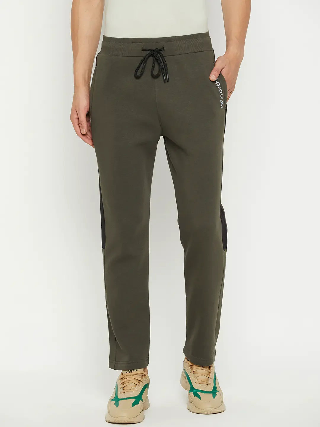 Model wears 98degreenorth Men’s Olive Fleece Trackpants with side panel and tan-green sneakers, against white backdrop.