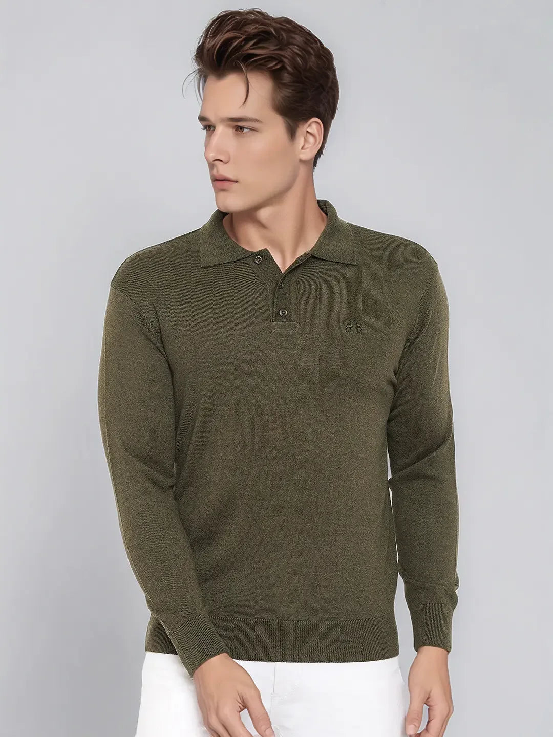Man wears 98degreenorth Men’s Olive Merino Wool Polo Neck Sweater with white pants, looking left against gray background.
