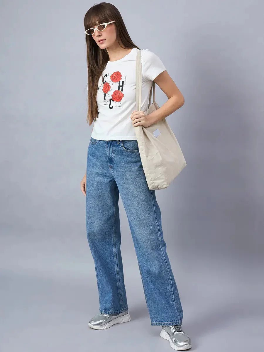 Woman in sunglasses wears a 98degreenorth round-neck cotton tee with bold typography print, blue jeans, and tote bag.