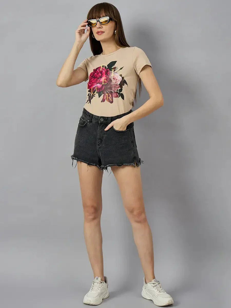 Woman in sunglasses wears a 98degreenorth casual typography t-shirt, black denim shorts, and white sneakers.