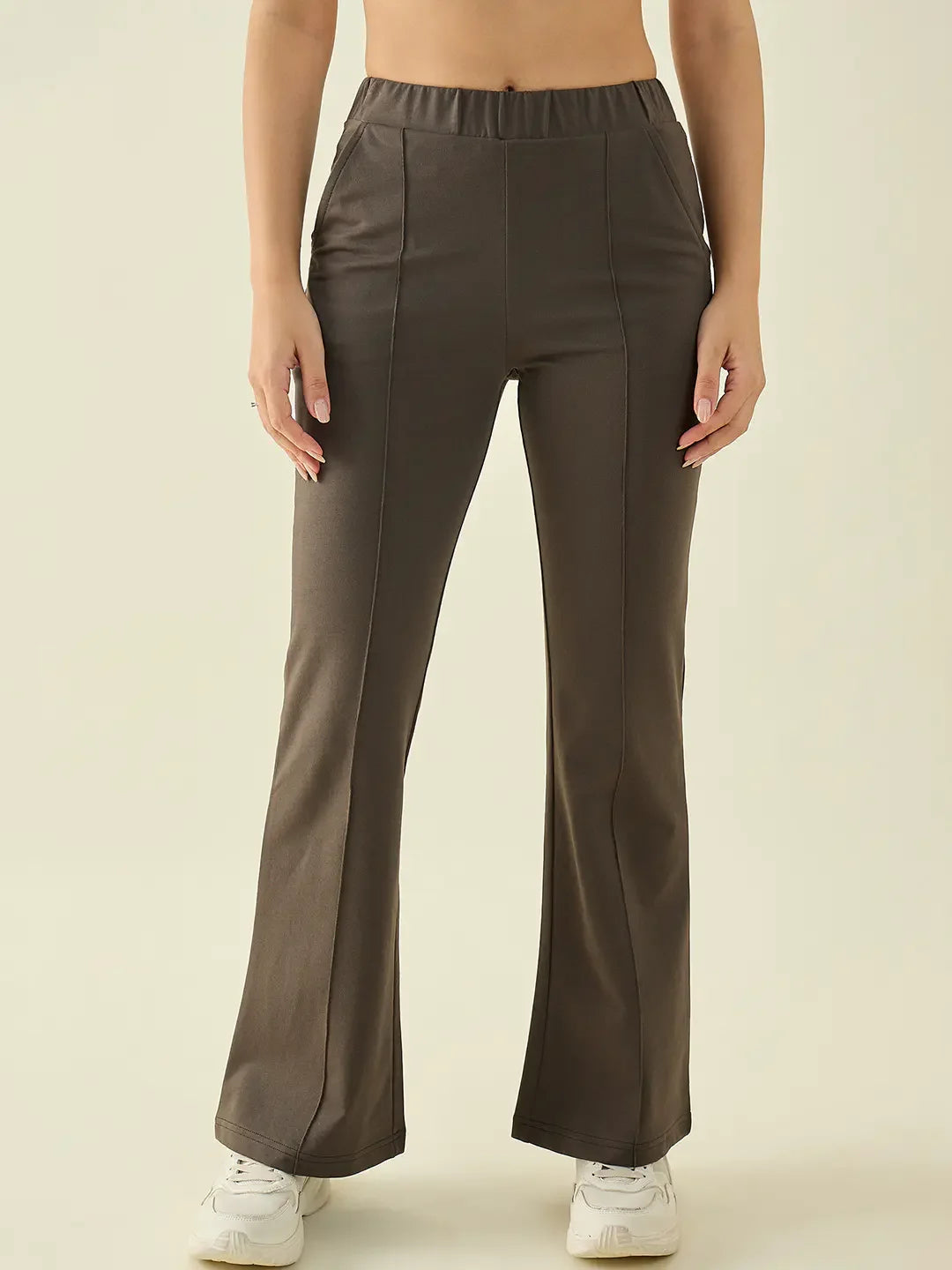 Woman in 98degreenorth Olive Flared Bootcut Cotton Stretchable Trousers, standing against a plain light background.