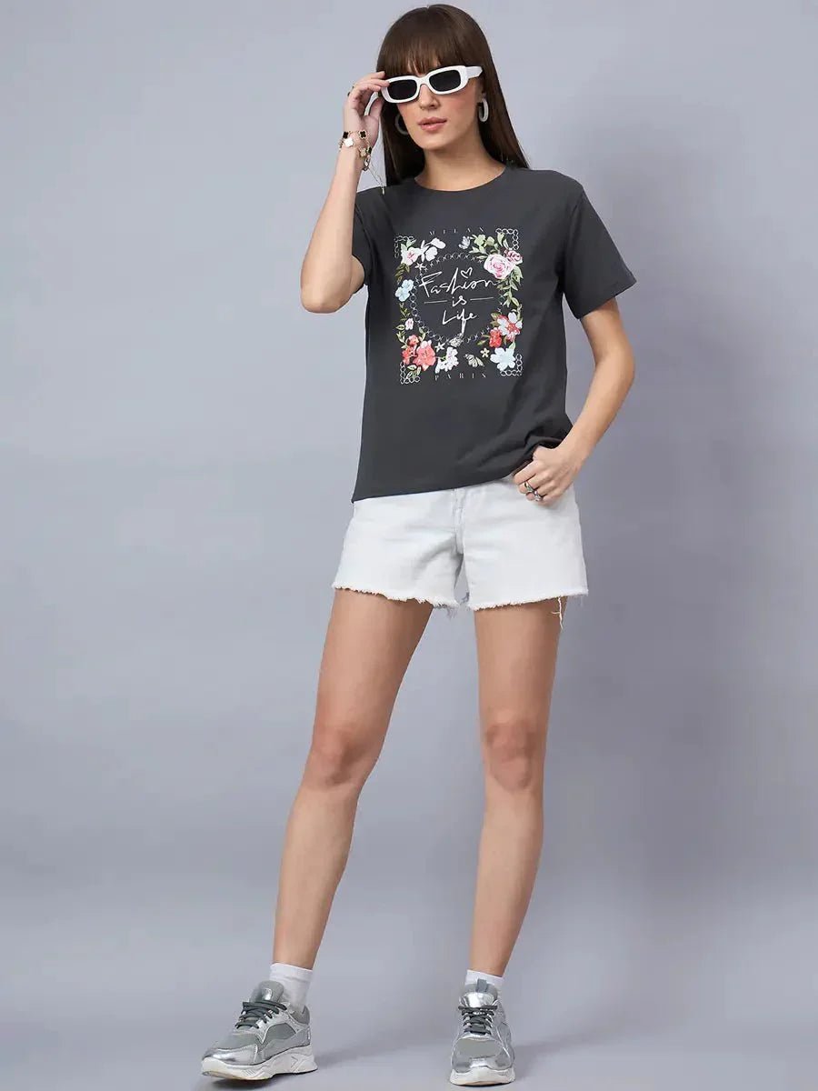 Woman in a 98degreenorth Women’s Relaxed Fit Typography Printed Cotton Tee poses against a gray background.