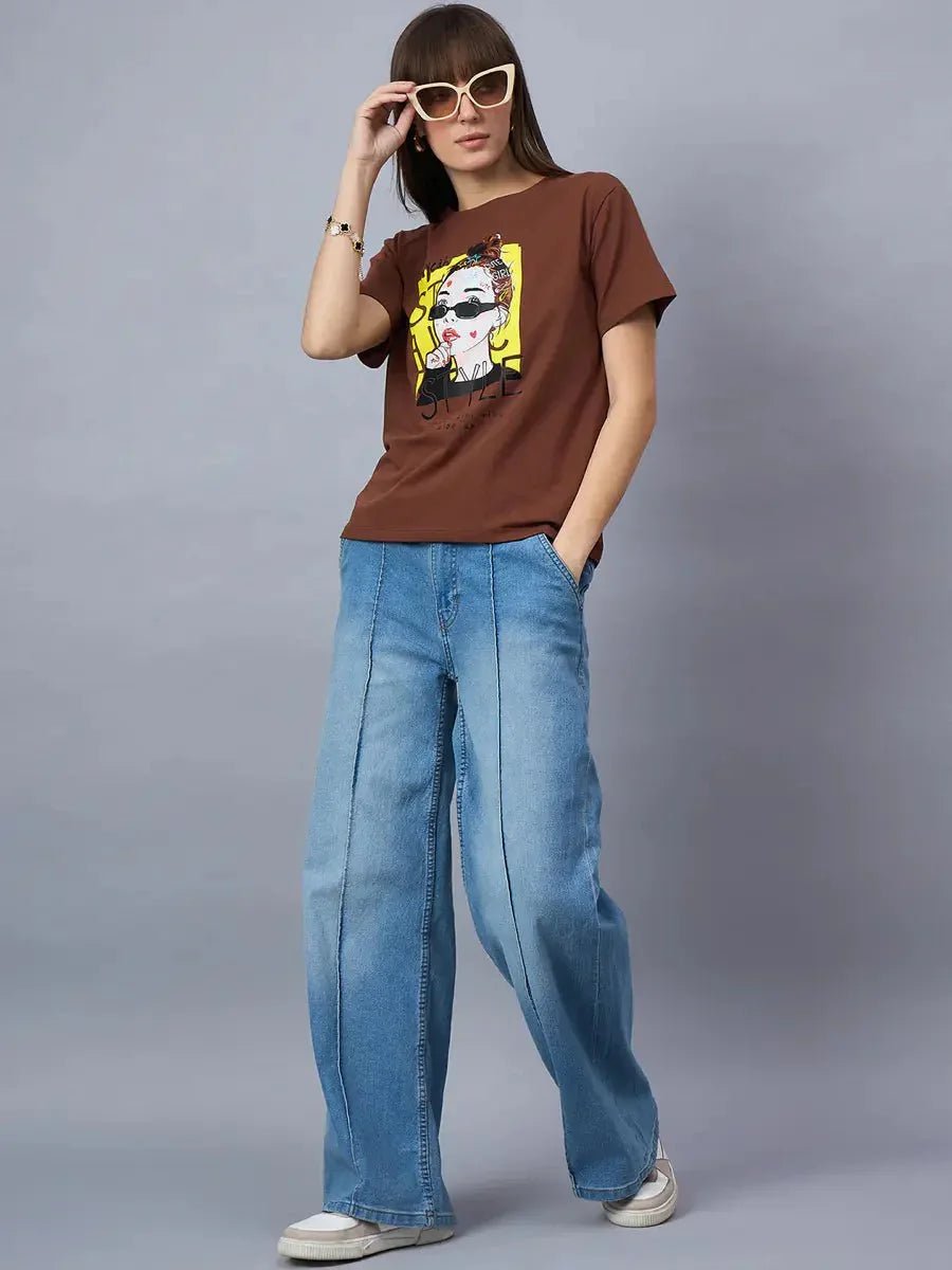 Woman in sunglasses styles 98degreenorths Graphic Cotton T-shirt with wide-leg jeans for a cool streetwear look.