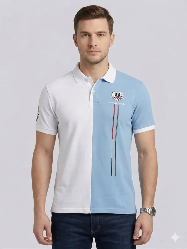 A man wearing a black long-sleeve polo shirt with a chest pocket and blue jeans stands against a plain white background, looking straight ahead.