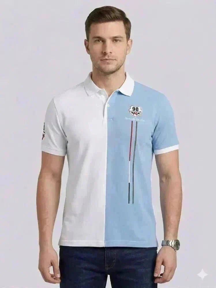 A man wearing a black long-sleeve polo shirt with a chest pocket and blue jeans stands against a plain white background, looking straight ahead.