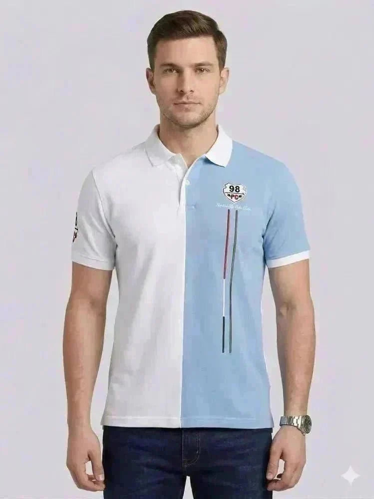 A man wearing a black long-sleeve polo shirt with a chest pocket and blue jeans stands against a plain white background, looking straight ahead.