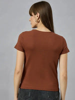 A woman with straight brown hair in a 98degreenorth breathable cotton tee with typography print and dark jeans, back turned.