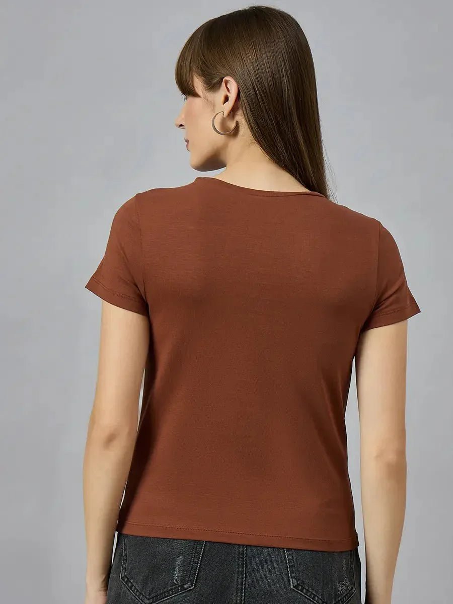 A woman with straight brown hair in a 98degreenorth breathable cotton tee with typography print and dark jeans, back turned.