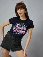 Woman wears a 98degreenorth must-have cotton typography t-shirt, perfect with denims, shorts, or joggers.