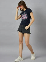 Woman in 98degreenorth’s must-have cotton typography t-shirt, styled with black shorts and pink sunglasses.