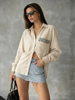 Woman in sunglasses, 98degreenorth Beige Aztec Embroidered Pocket Cotton Shirt, and a frayed denim mini skirt.