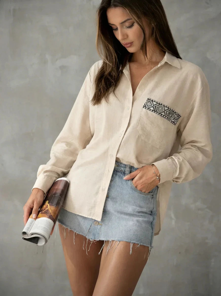 Woman wearing the 98degreenorth Beige Aztec Embroidered Pocket Cotton Shirt, holding a magazine.