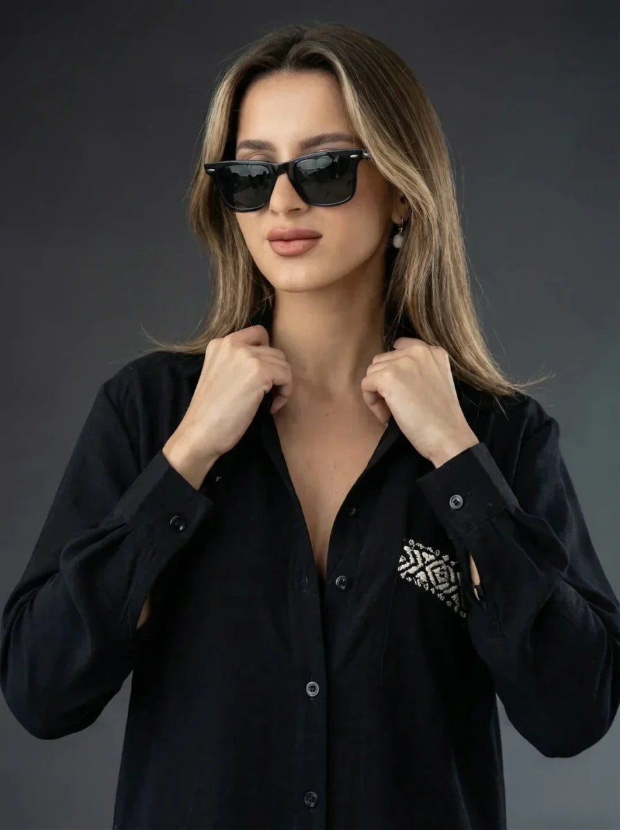 Woman wears 98degreenorth Black Aztec Embroidered Cotton Shirt, posing confidently against a dark background.
