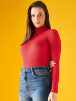 Woman in a 98degreenorth bright red ribbed turtleneck sweater, blue jeans, against a vibrant yellow background.