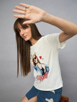 Woman with long brown hair wears the 98degreenorth Casual Streetwear Cotton Typography T-shirt and a denim skirt, smiling.