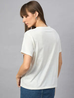 Woman with long brown hair in a 98degreenorth Casual Streetwear Cotton Typography T-shirt, facing away from camera.