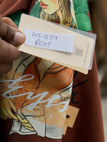 A hand holds a GT-1654 RDT card over a 98degreenorth Casual Typography Print Cotton T-shirt for Women.