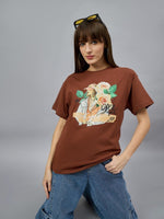 Woman in a 98degreenorth Casual Typography Print Cotton T-shirt and jeans poses, embracing streetwear fashion.