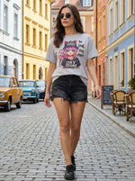 Woman in sunglasses wears a 98degreenorth Classic Cotton Typography Print Drop Shoulder T-shirt on a vibrant city street.