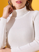 Woman in a 98degreenorth Classic White Women’s Ribbed Stretchable Turtleneck Sweater, with hoop earrings on yellow.