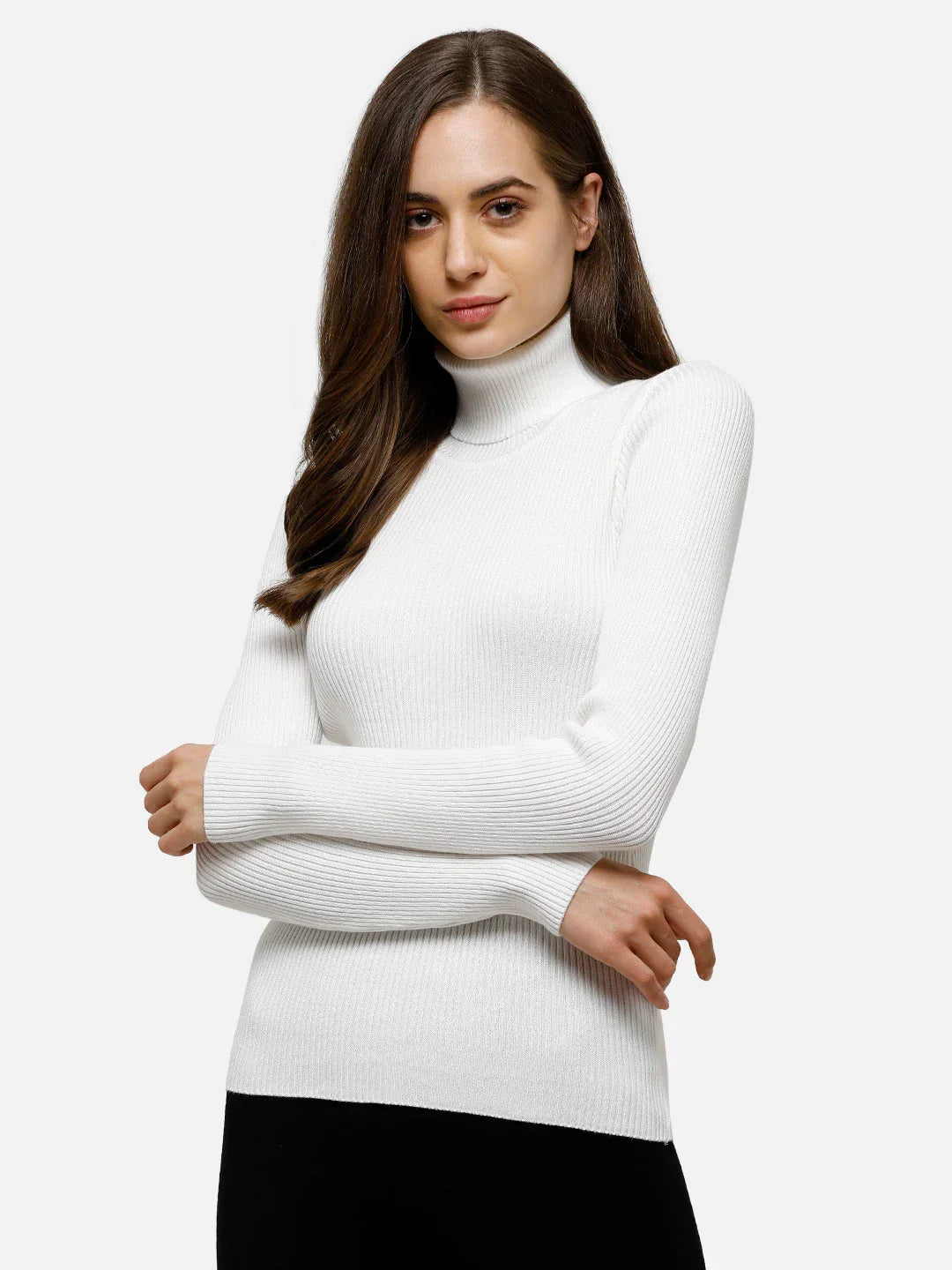 Woman wears 98degreenorth Classic White Ribbed Turtle Neck Sweater, styled with black pants and arms crossed.