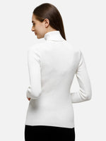 Woman wearing 98degreenorth Classic White Ribbed Turtle Neck Sweater, pictured from the back with head turned.