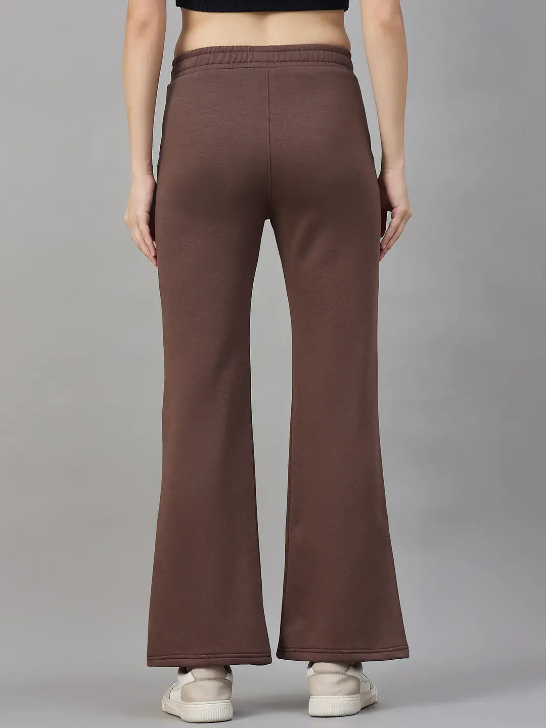 A model wears 98degreenorth Cocoa Brown Women's Fleece Flared Sweatpants, shown from the back against a grey backdrop.