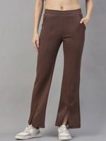 Model wears 98degreenorth Cocoa Brown Women’s Fleece Flared Sweatpants with front slits, white sneakers, and a crop top.