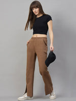 Woman in a black crop top and 98degreenorth Coffee Melange Women’s Fleece Bootcut Sweatpants stands by a gray backdrop.