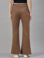 Model in 98degreenorth Coffee Melange Women’s Fleece Bootcut Sweatpants and white shoes, shown from the back against gray.