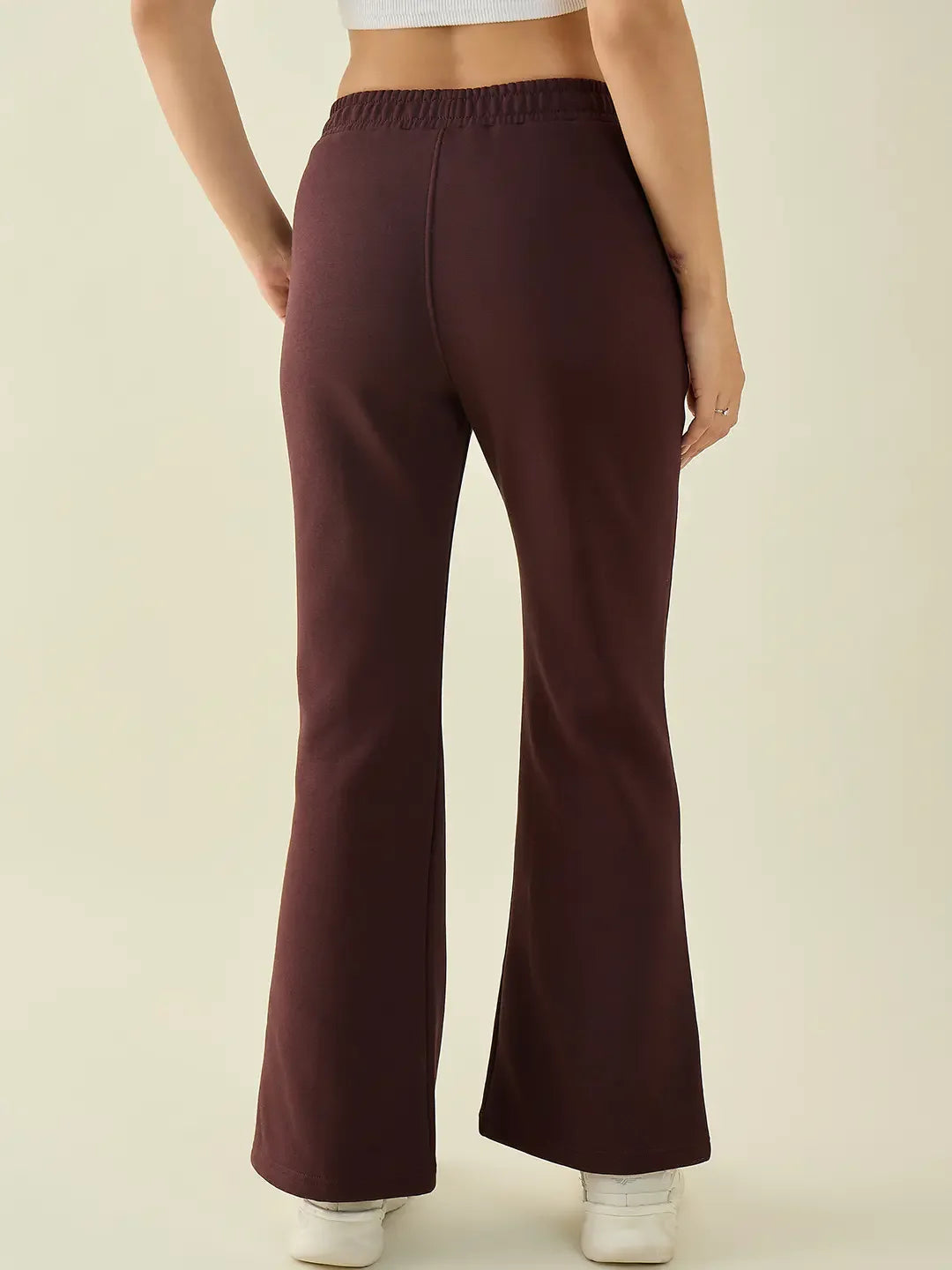 Woman in 98degreenorth Dark Wine Fleece Flared Sweatpants—bootcut winter pants, India style.