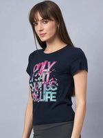 Woman in 98degreenorths soft cotton typography t-shirt, a daily essential, stands against a gray background.