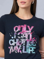 A woman wears a 98degreenorth soft cotton t-shirt with only I can change my life in bold, colorful letters.