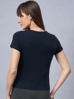 Woman with straight brown hair wears 98degreenorths soft cotton typography t-shirt, shown from the back.