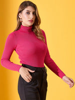 98degreenorth Fuchsia Women’s Ribbed Stretch Turtleneck Sweater styled with black pants, posed on a yellow background.