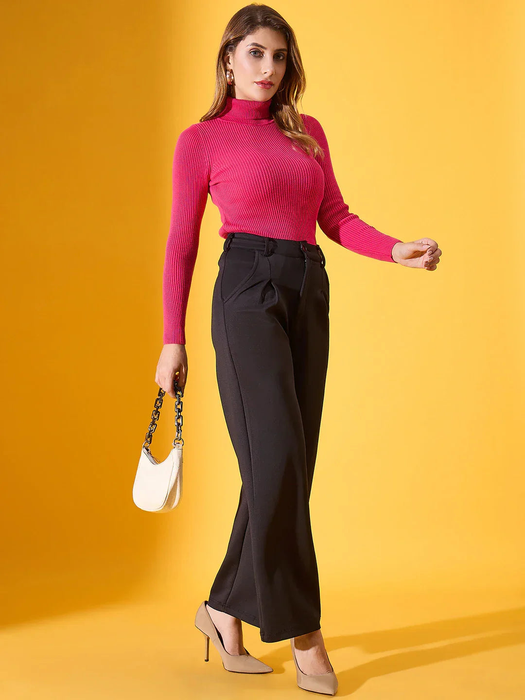 Woman in 98degreenorth Fuchsia Ribbed Stretch Turtleneck Sweater, black pants, beige heels, with white handbag.