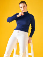 Woman in 98degreenorth Indigo Ribbed Knit Turtleneck Sweater showcases slim fit winter fashion for women in India.