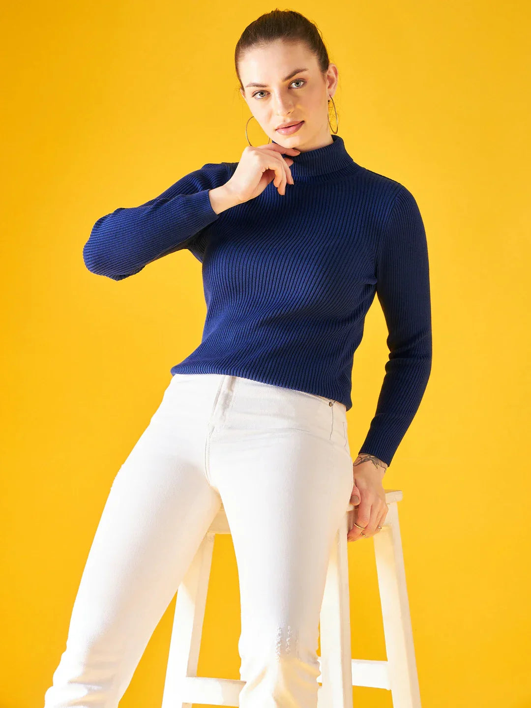 Woman in 98degreenorth Indigo Ribbed Knit Turtleneck Sweater showcases slim fit winter fashion for women in India.