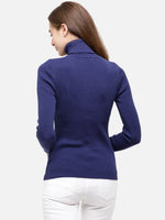 Woman with long brown hair wears the 98degreenorth Ink Blue Ribbed Turtleneck Sweater, facing away from the camera.