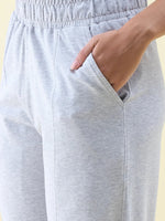 Close-up of a person wearing 98degreenorth Light Grey Wide Leg Pintuck Trackpants from the Luxe Lounge collection.