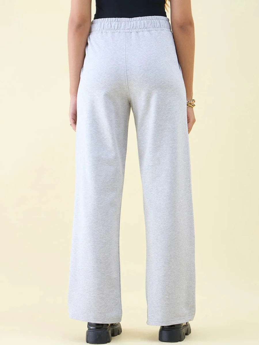 Model wears 98degreenorth Light Grey Wide Leg Pintuck Trackpants and black boots, shown from the back on a plain background.