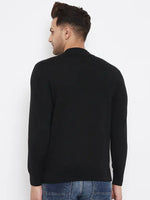 A man stands against a white background, facing away, wearing 98degreenorth’s Men Merino Wool Black Turtleneck Pullover paired with blue jeans.