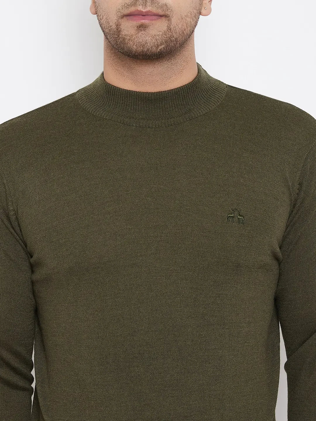 A person wears a 98degreenorth Men Merino Wool Olive Turtleneck Pullover, long-sleeve and ribbed with a small left-chest logo, shown from shoulders to mid-torso against a plain white background.