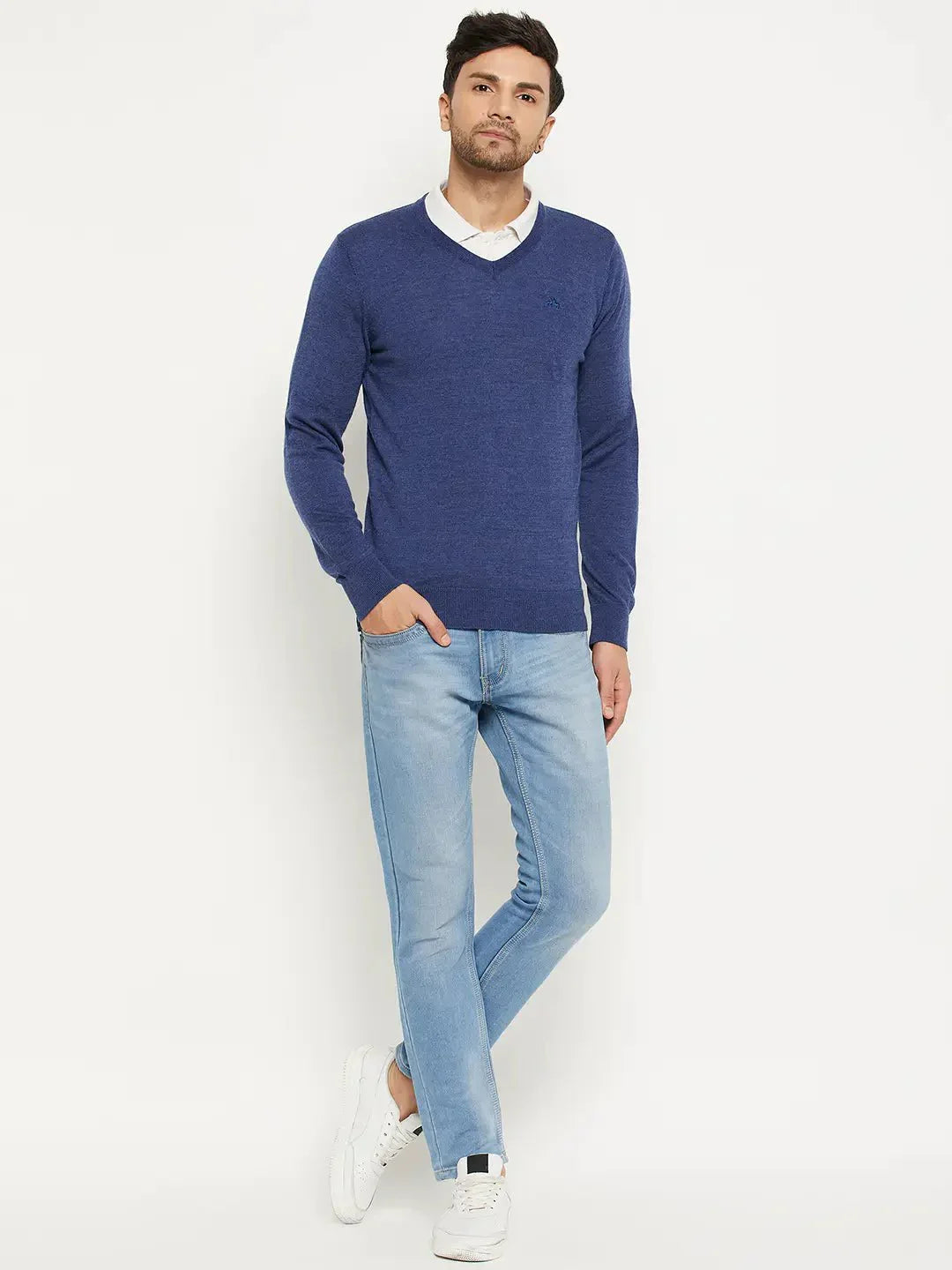 A man in a 98degreenorth Men Merino Wool V-Neck Pullover Light Denim poses against a white background.